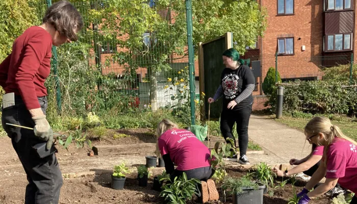 Staff from Experian planting at St Ann's Allotments