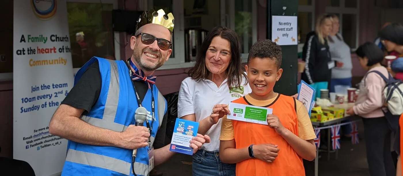 Three people at an event, smiling into the camera