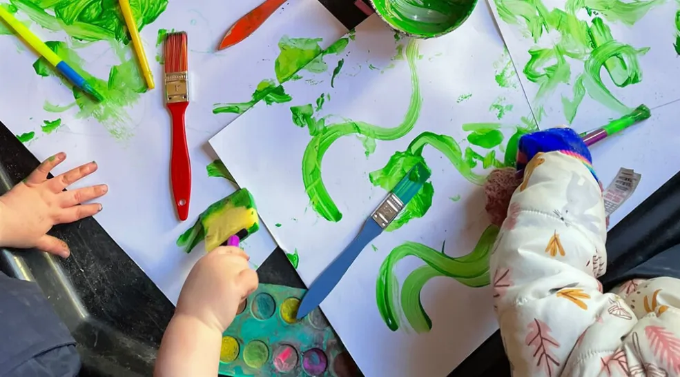 A children's painting activity at Mini Movers
